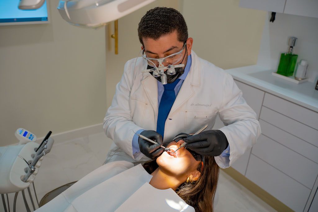 Dr. Husam Almunajed performing a cosmetic dentistry procedure at Empire Dental Aesthetics