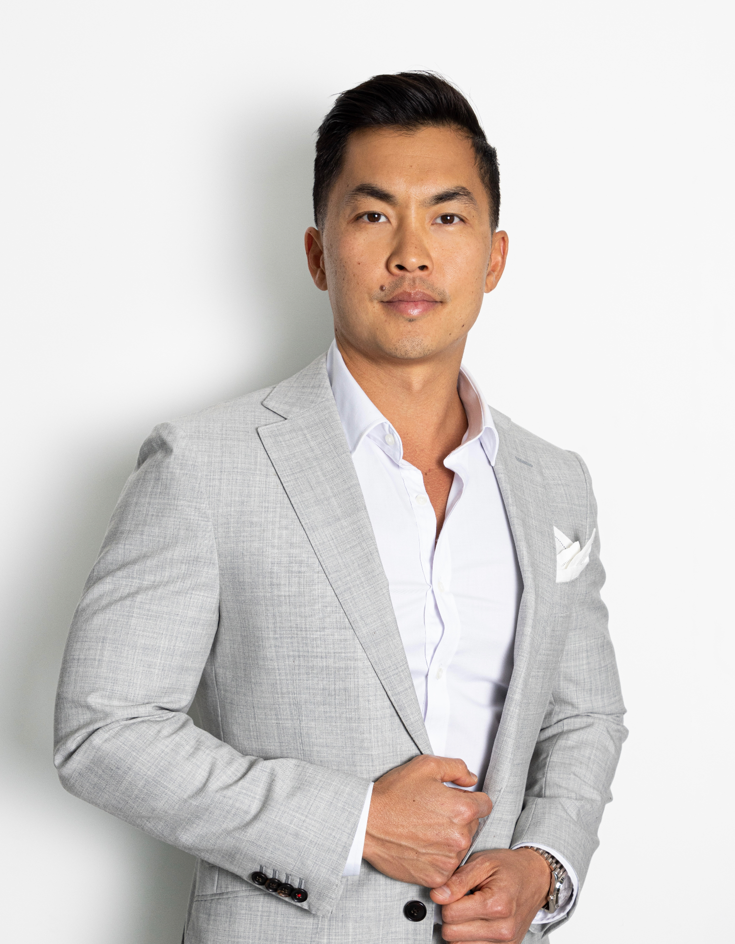 Dr. Oliver Chang in a light gray blazer and white shirt