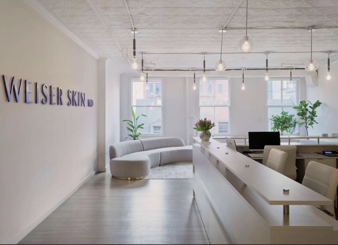 The bright, minimalist reception area of Weiser Skin MD on Spring Street in SoHo, New York